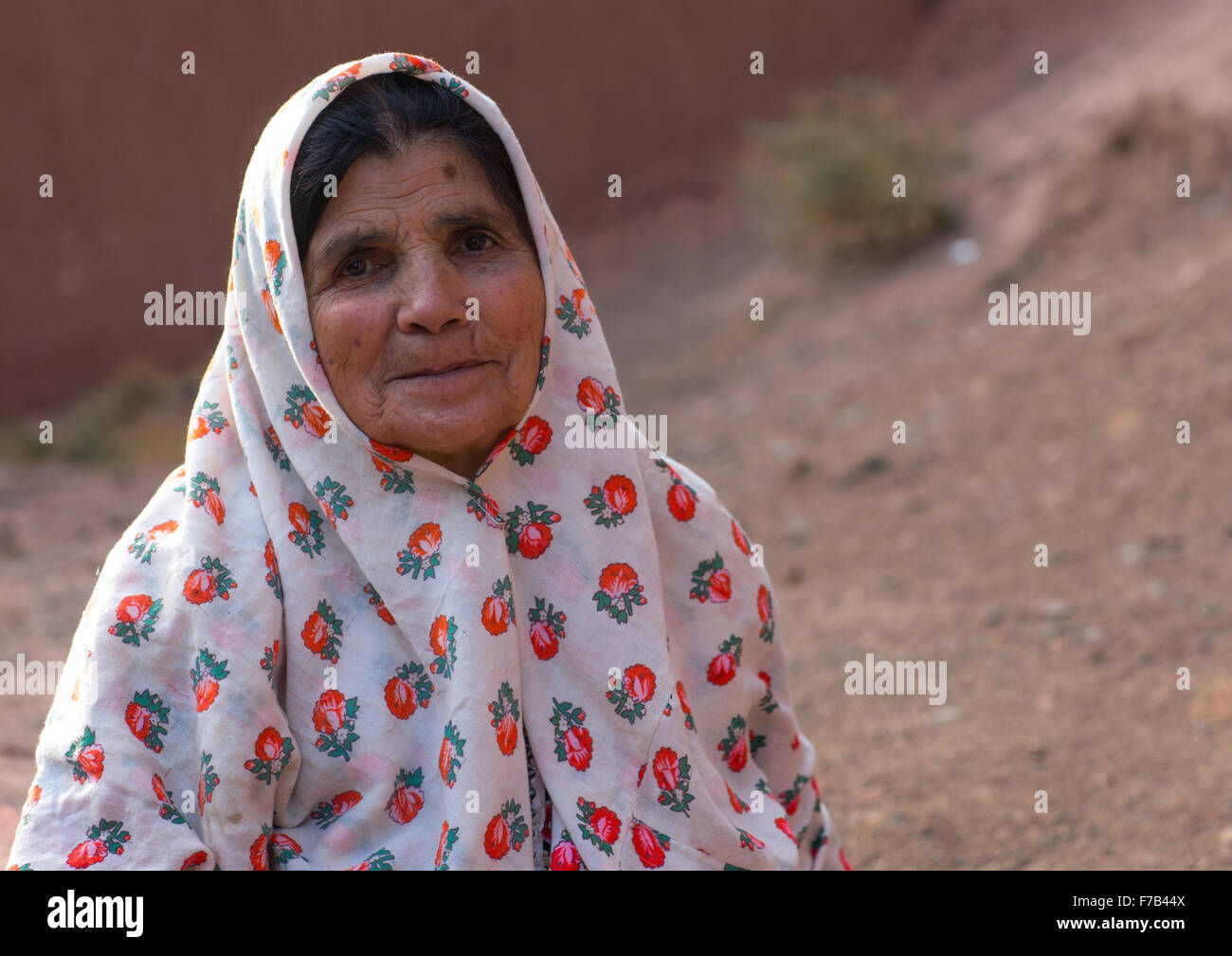 Portrait Of An Iranian Woman Wearing Traditional Floreal Chador In Zoroastrian Village, Isfahan Province, Abyaneh, Iran Stock Photo