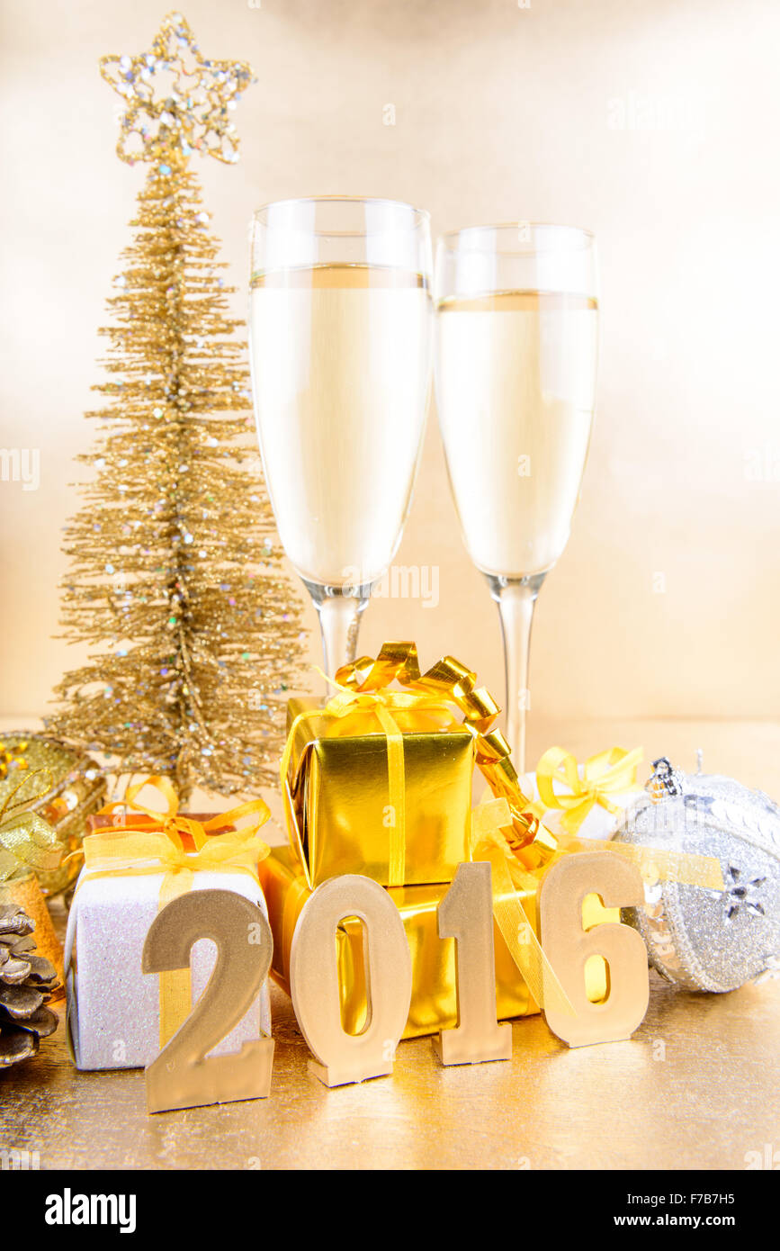 New Year composition with champagne and gifts on gold background Stock ...