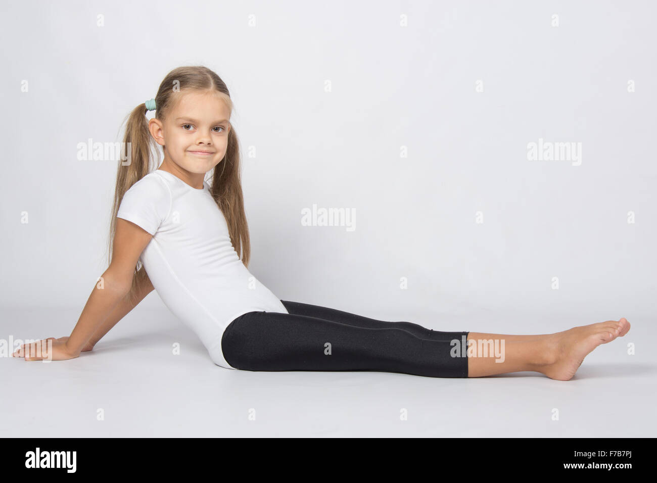 six year old girl aspiring gymnast performs a number of training
