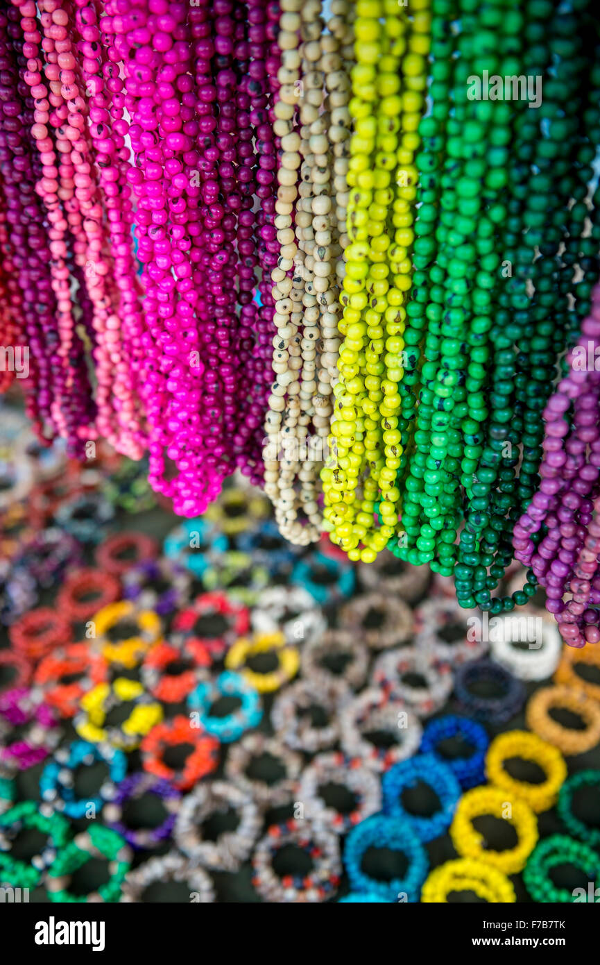 Bright background of handmade strands of colorful beads and bracelets at the Feira Hippie outdoor crafts market in Rio, Brazil Stock Photo