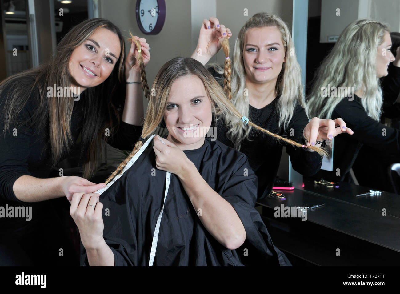 Young Woman Having Her Hair Cut Off For Charity By Hairdressers At