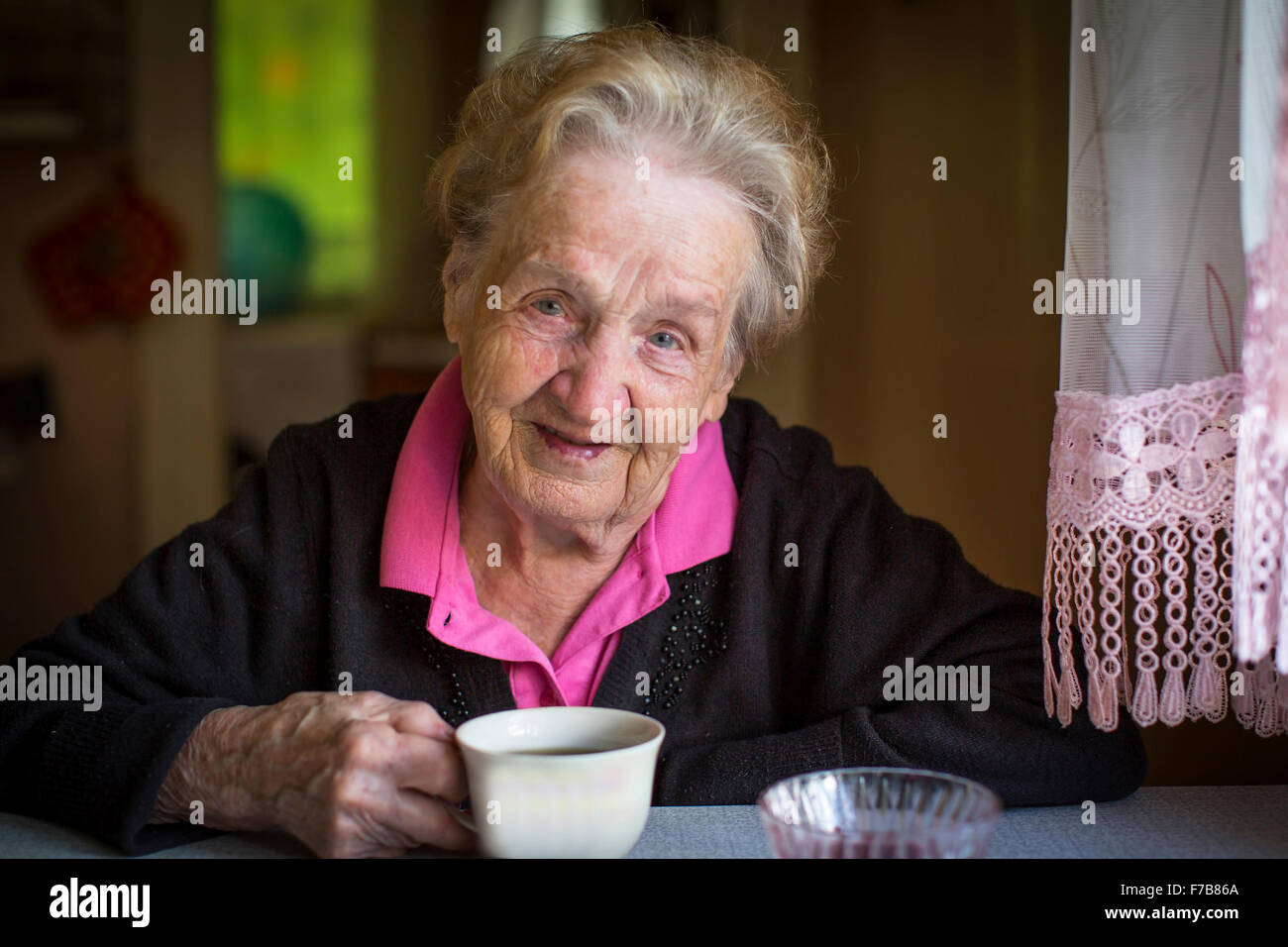 Older woman drinking tea sitting hi-res stock photography and images ...