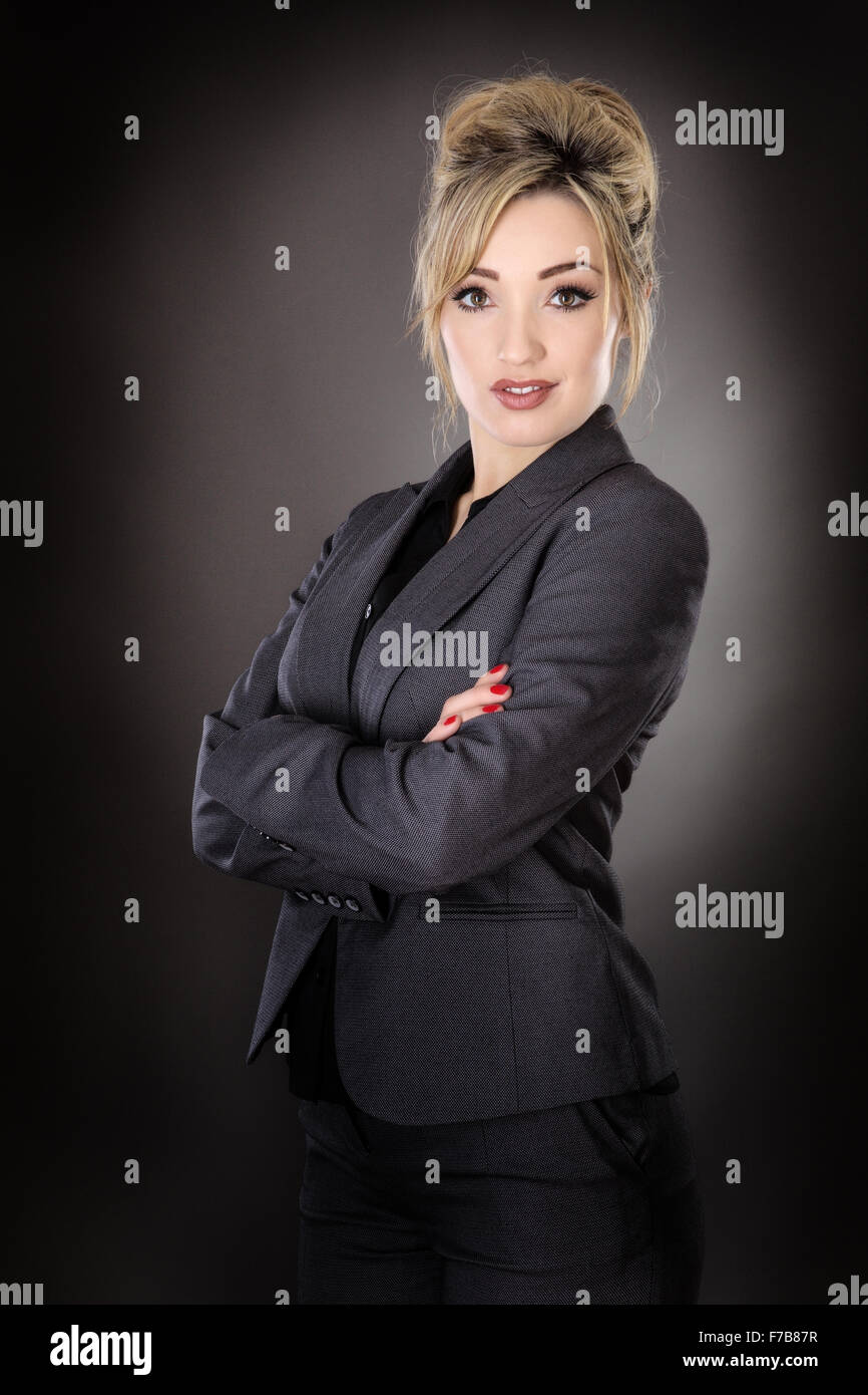 Standing business woman shot in the studio on a grey background Stock ...
