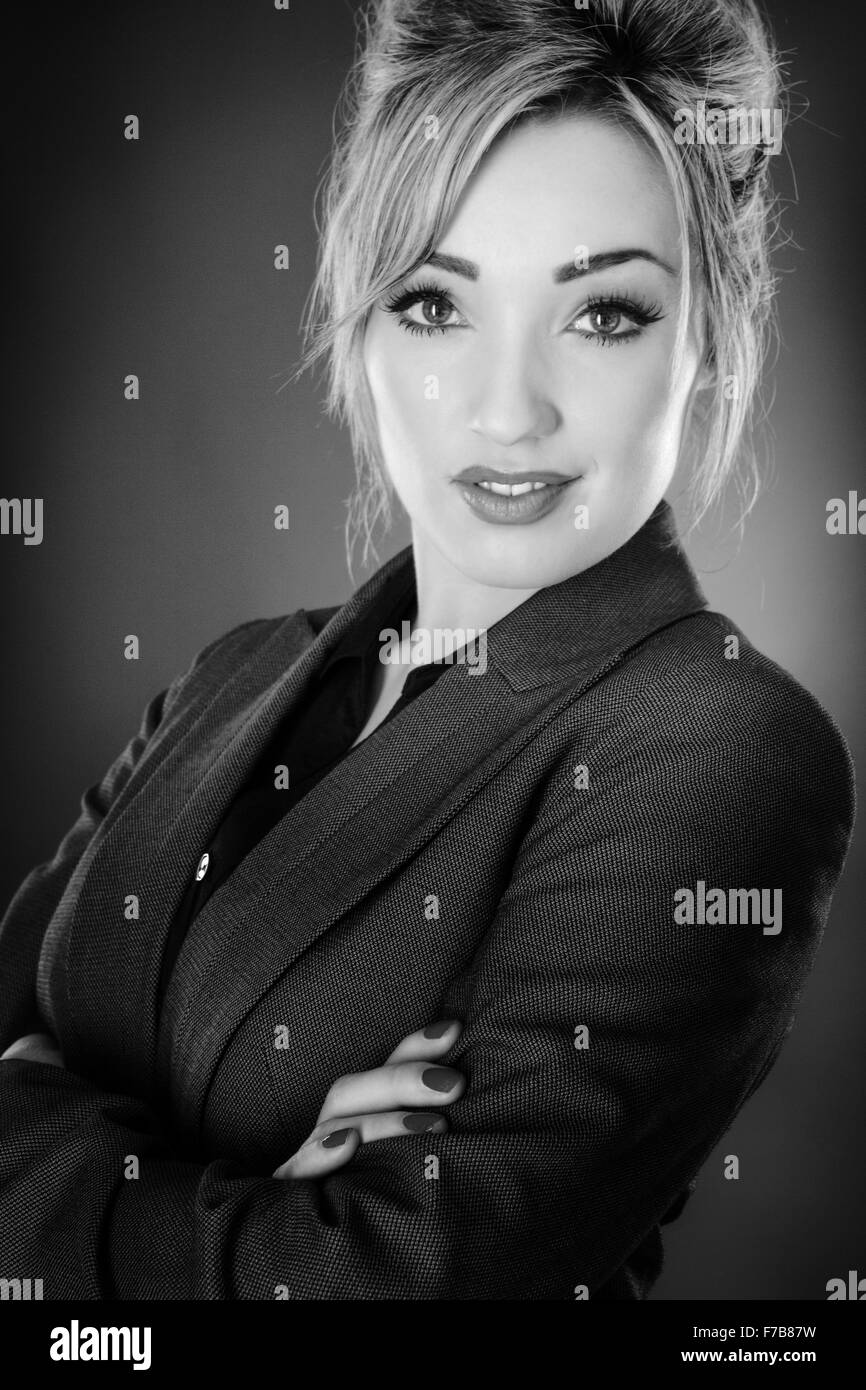 Standing business woman shot in the studio on a grey background Stock ...