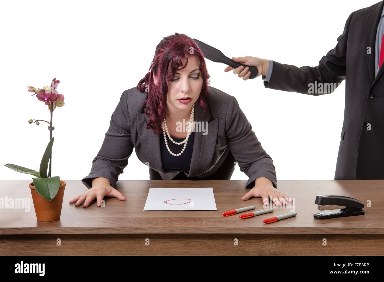 secretary bent over desk being smacked by her boss with a Spanking