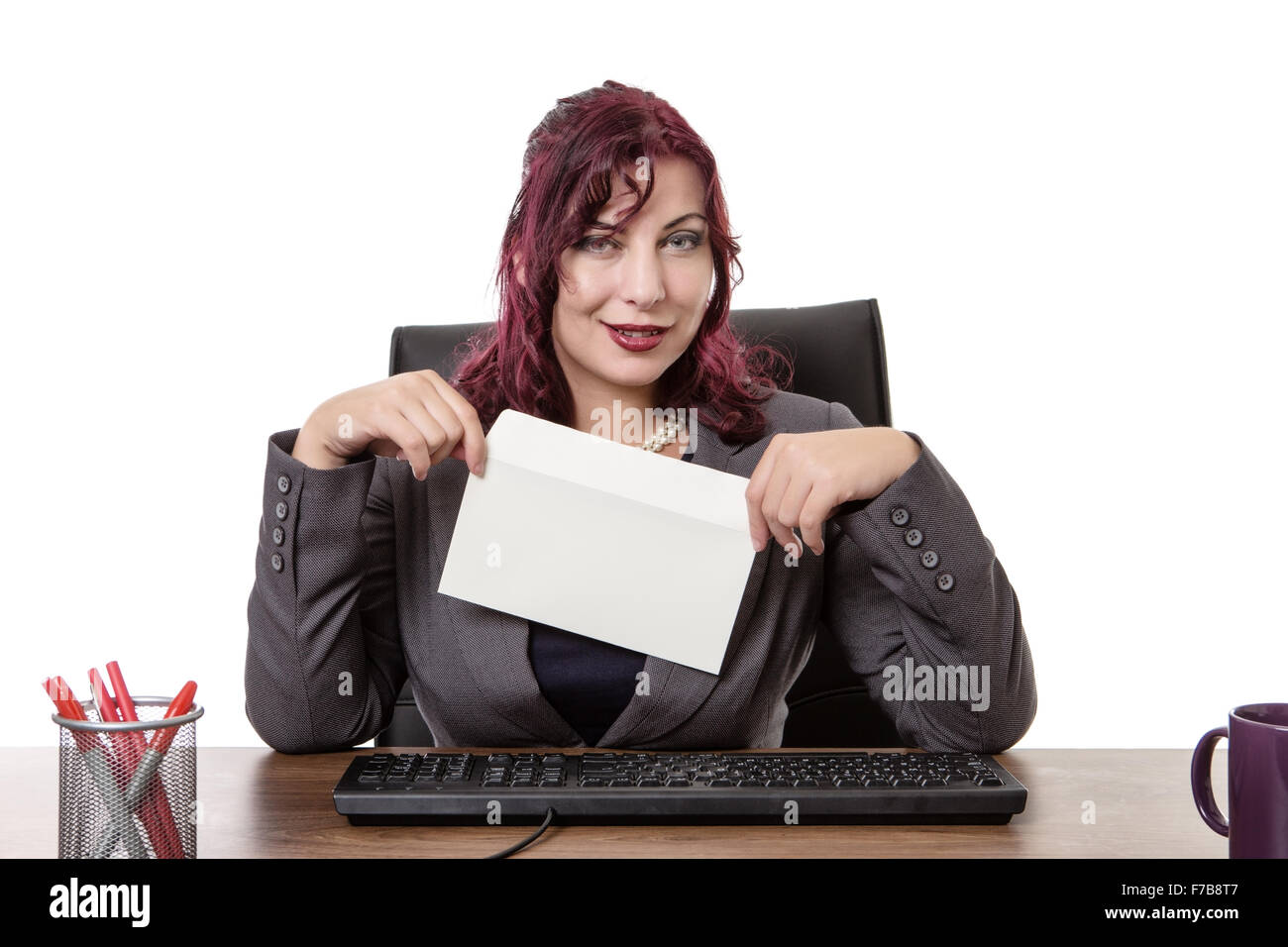 business woman licking envelope sitting a her desk Stock Photo Alamy