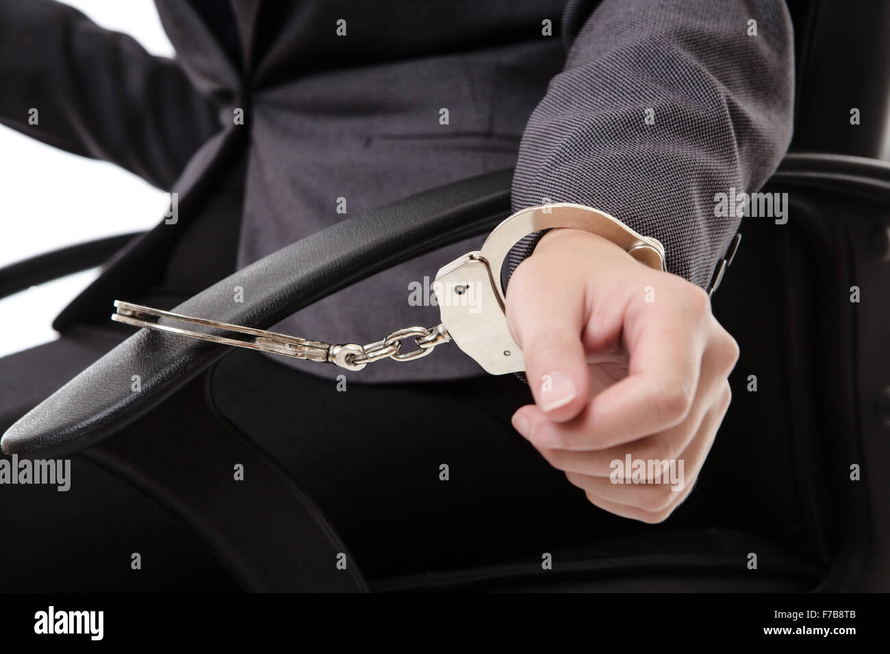 Photograph of womans hand in handcuffs (closeup) cuffed to an office chair Stock Photo Alamy