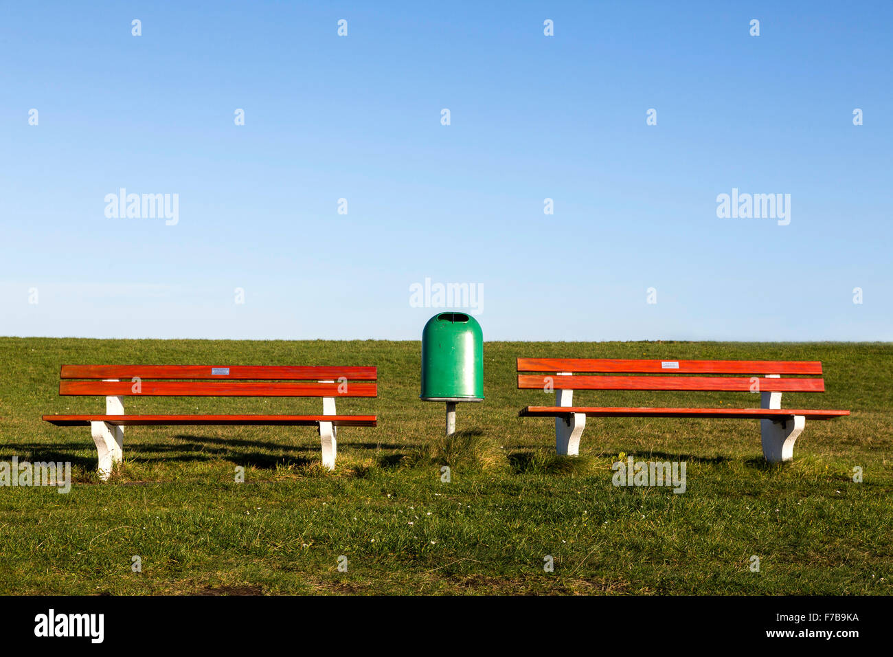 Two empty park benches on a dike, rubbish box, Stock Photo
