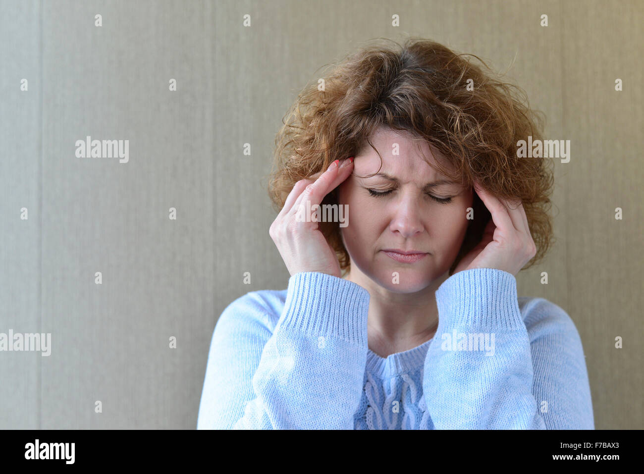 Woman holding hands on head, depression, pain, migraine Stock Photo