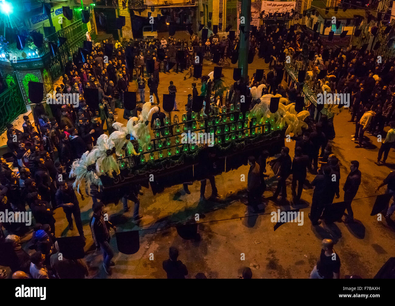Iranian Shiite Muslim Men Mourners With An Alam In A Mosque Courtyard On Ashura, The Day Of The Death Of Imam Hussein, Golestan Province, Gorgan, Iran Stock Photo