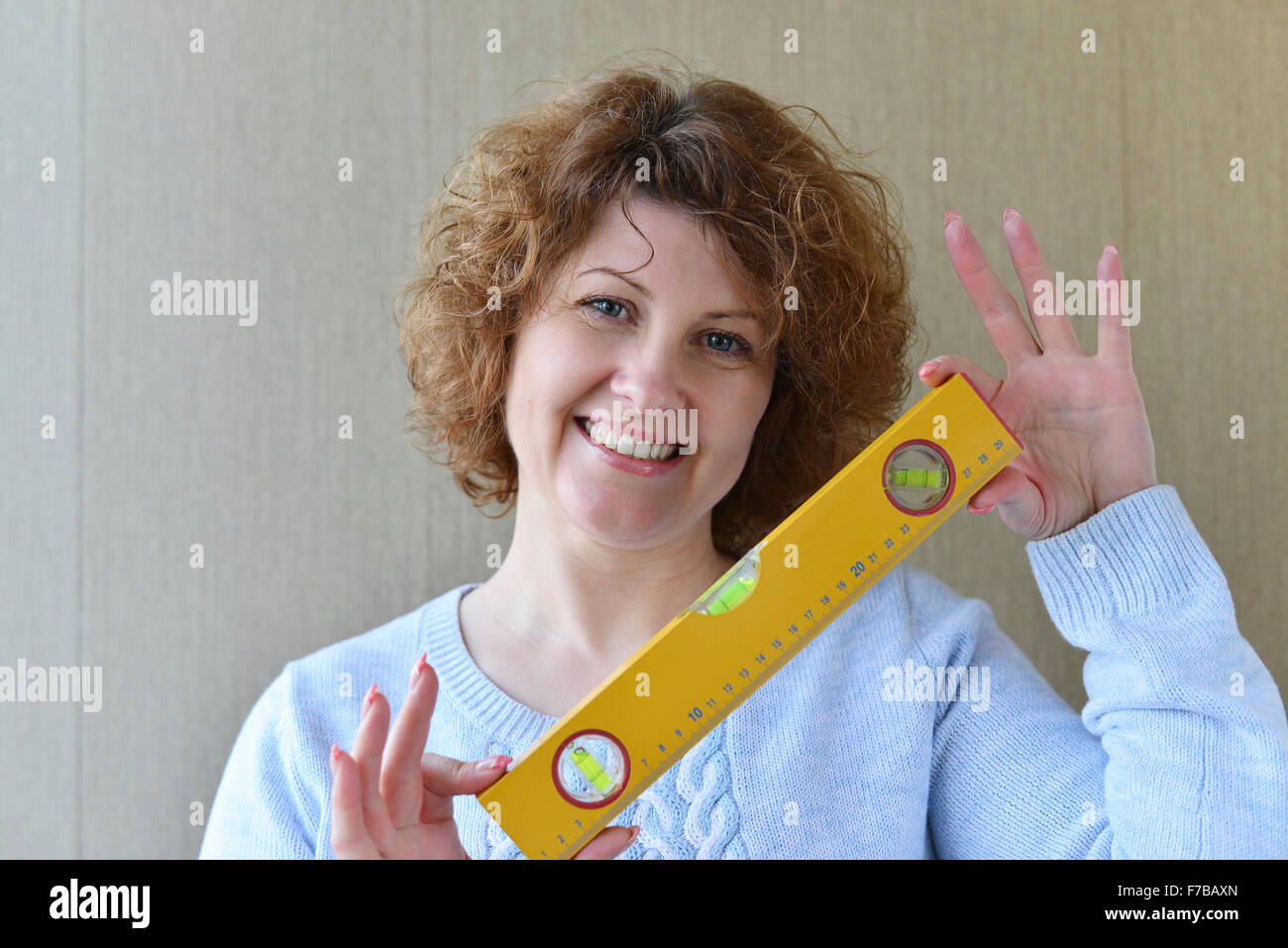woman is holding construction tools Stock Photo