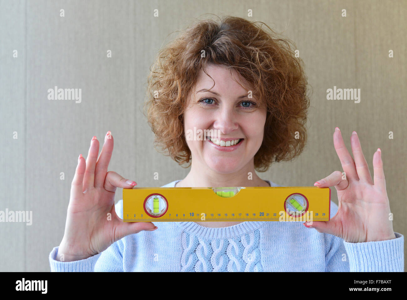 woman is holding construction tools Stock Photo