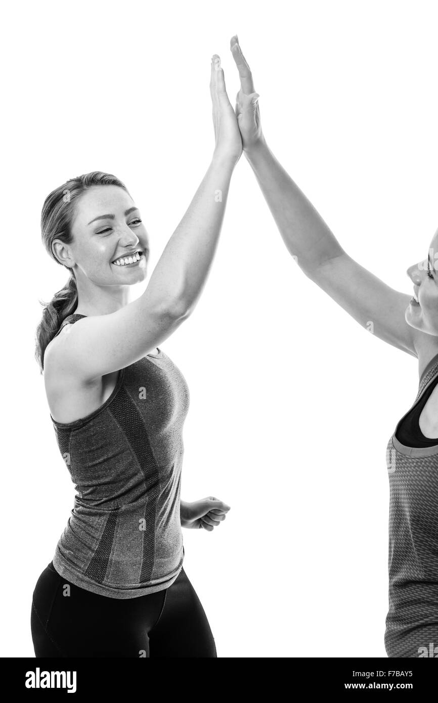 two fitness woman high fiving each other Stock Photo