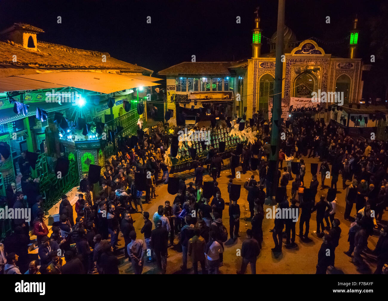 Iranian Shiite Muslim Men Mourners With An Alam In A Mosque Courtyard On Ashura, The Day Of The Death Of Imam Hussein, Golestan Province, Gorgan, Iran Stock Photo