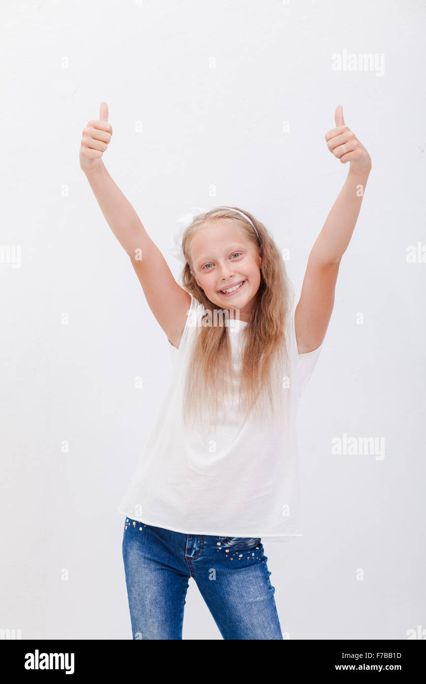 Portrait of a beautiful girl showing thumbs up on white Stock Photo - Alamy