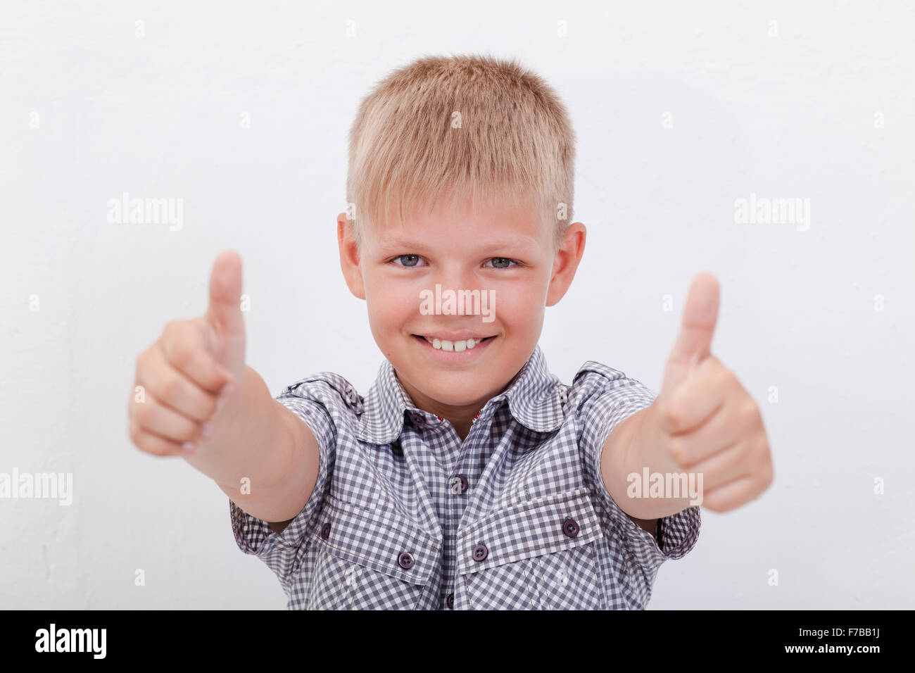 Portrait of happy boy showing thumbs up gesture Stock Photo - Alamy