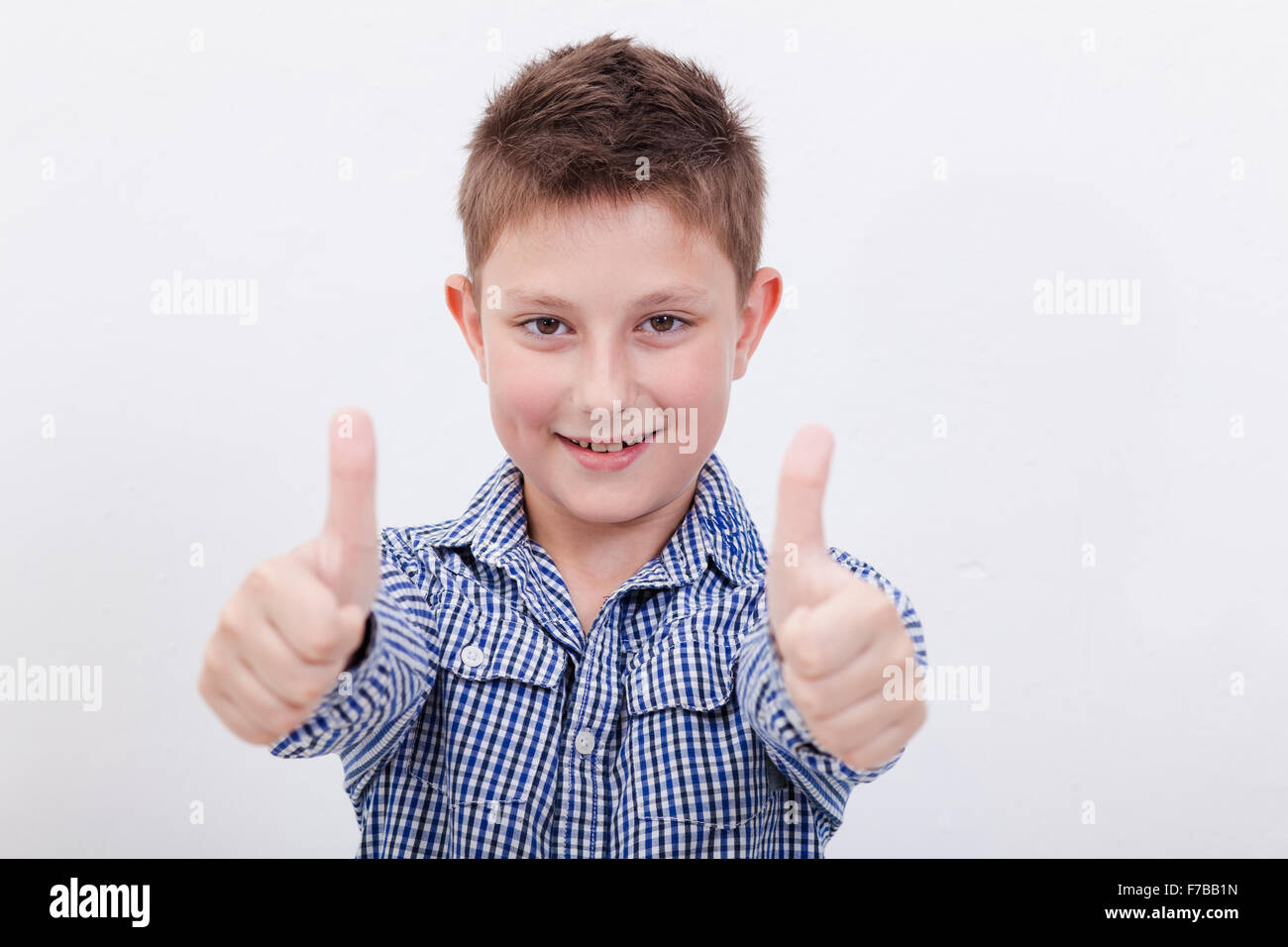 Portrait of happy boy showing thumbs up gesture Stock Photo - Alamy
