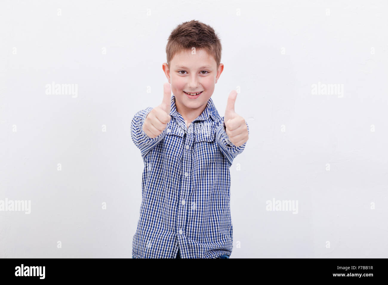 Portrait of happy boy showing thumbs up gesture Stock Photo - Alamy