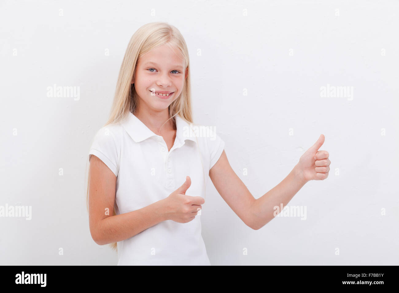 Portrait of a beautiful girl showing thumbs up on white Stock Photo - Alamy