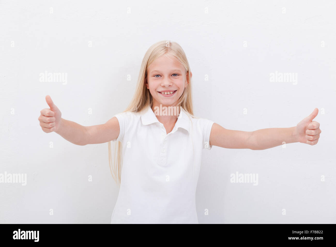 Portrait of a beautiful girl showing thumbs up on white Stock Photo - Alamy