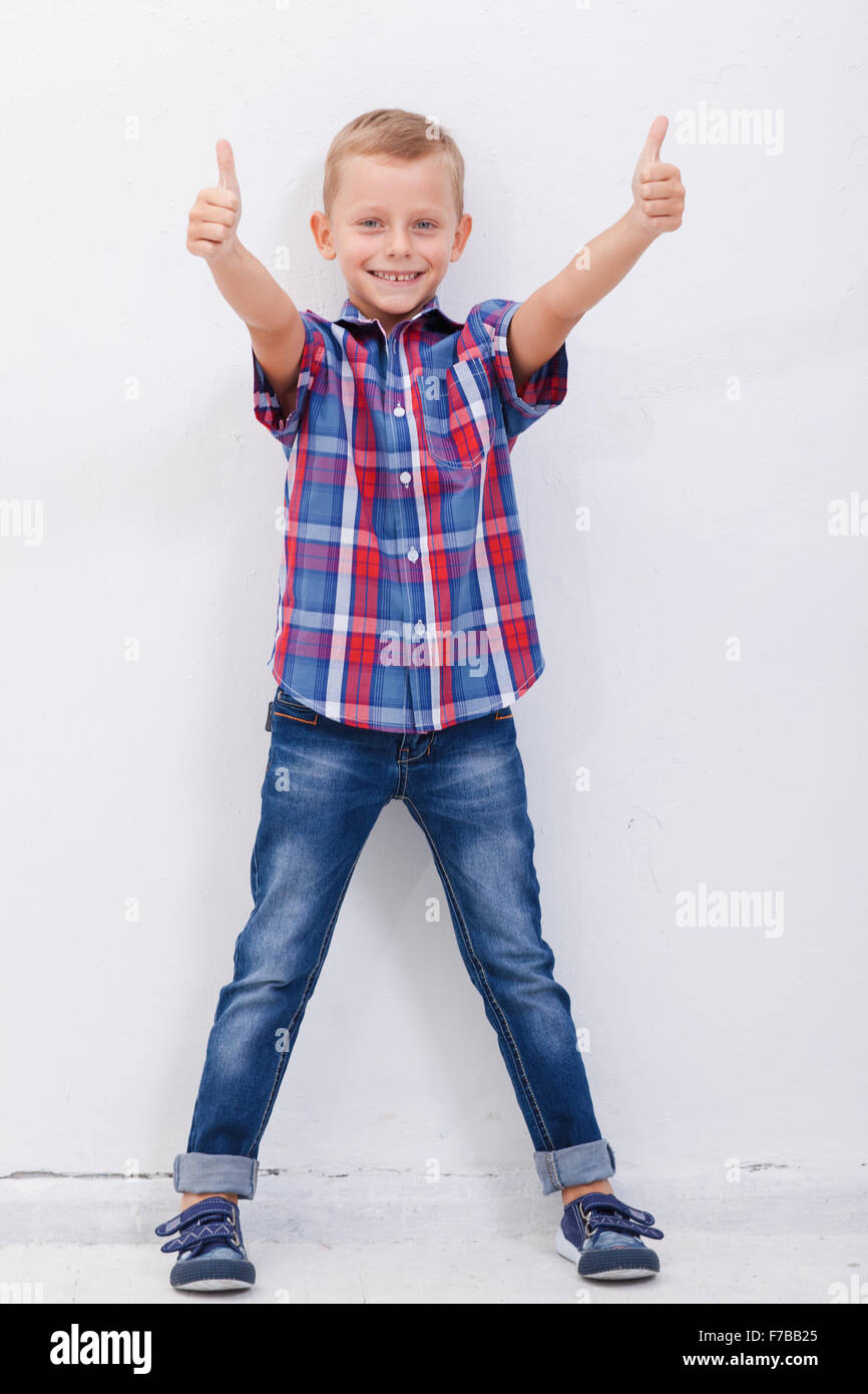 Portrait of happy boy showing thumbs up gesture Stock Photo - Alamy