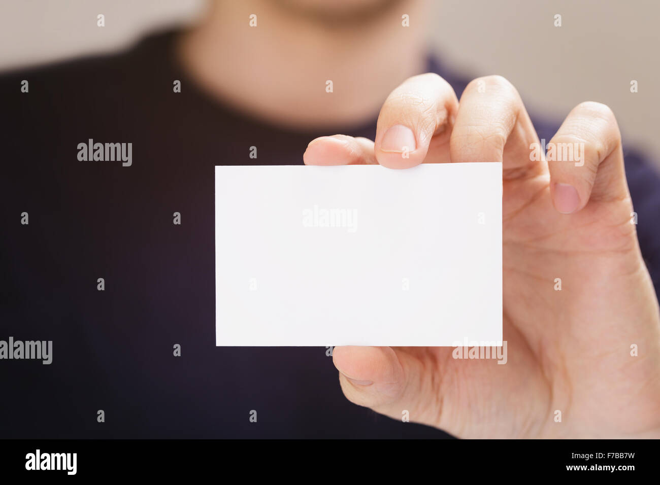 adult man hold business paper card closeup Stock Photo