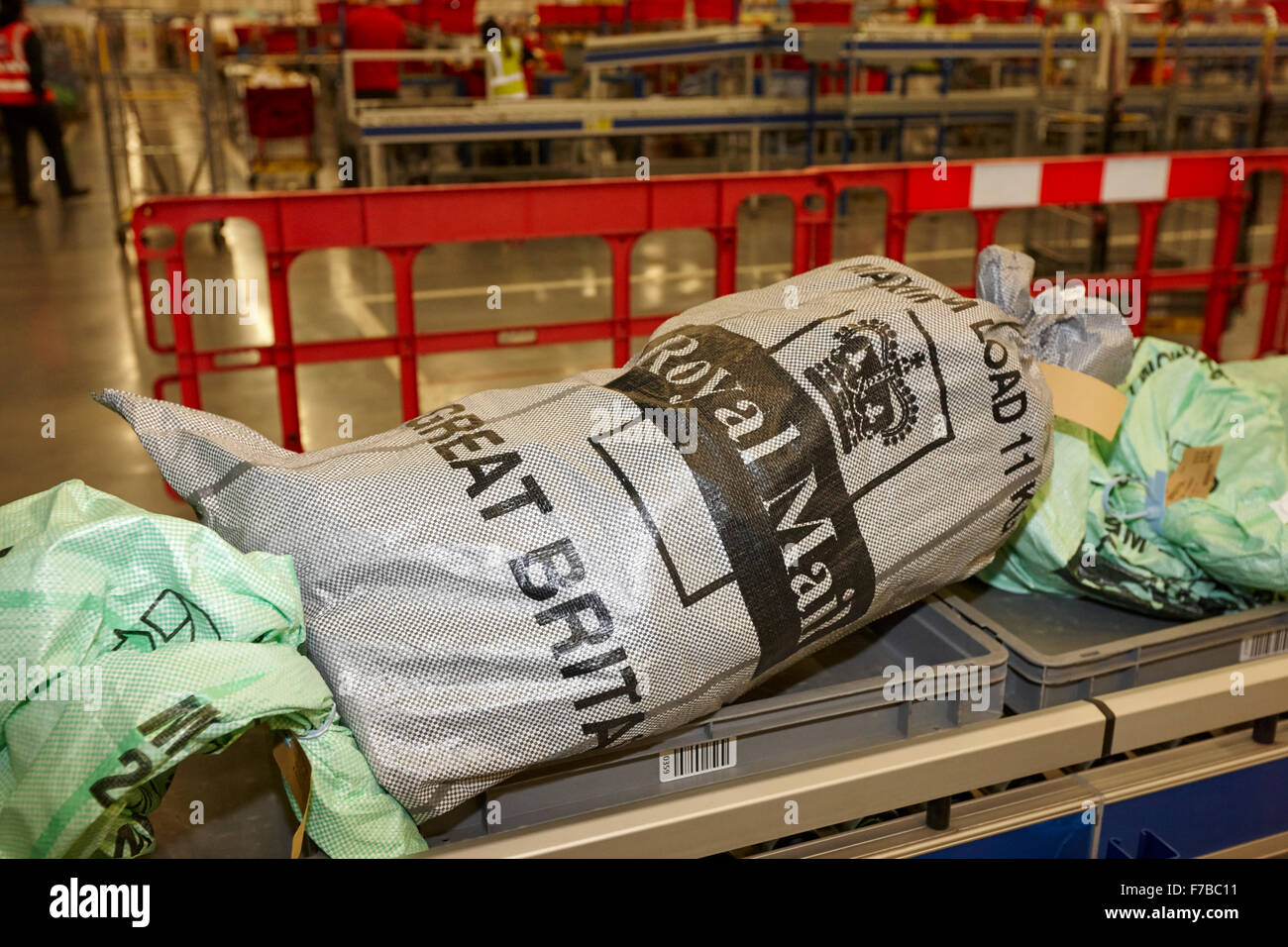 royal mail post mailbags on conveyor belt in sorting office in the uk Stock Photo