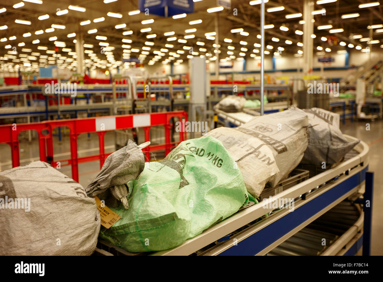 royal mail post mailbags on conveyor belt in sorting office in the uk Stock Photo