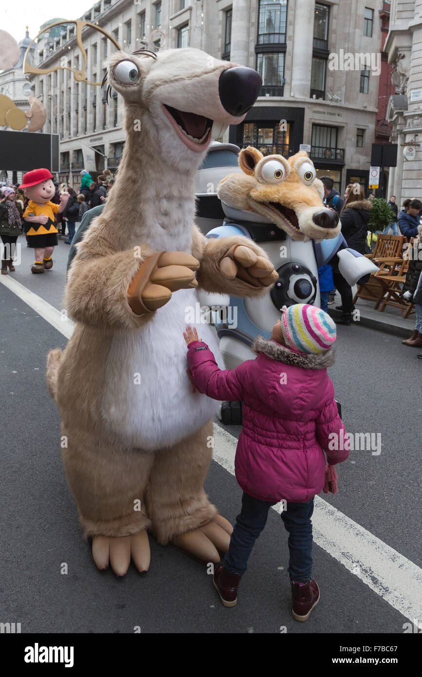 London, UK. 28 November 2015. Sid and Scrat from the Ice Age film interact with young fans. The inaugural Hamleys Christmas Toy Parade takes place along Regent Street, which went traffic-free for the day. The parade organised by the world-famous toy store Hamleys featured over 50 of the nation's favourite children's characters along with 400 entertainers, a marching band and giant balloons. The parade is modelled on Macy's annual Thanksgiving Parade in New York. Credit:  Vibrant Pictures/Alamy Live News Stock Photo