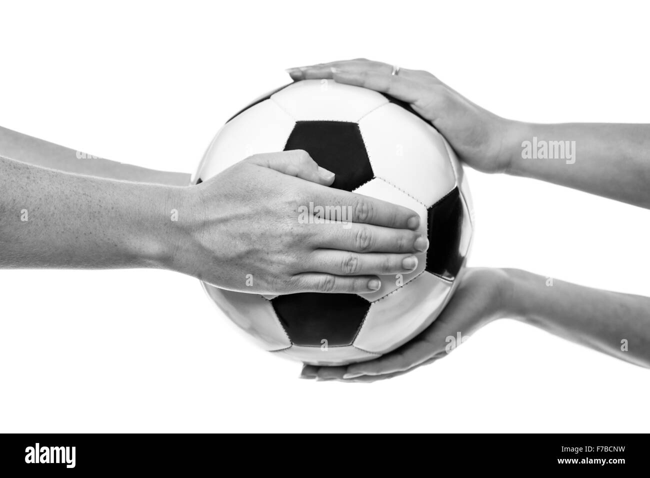 two female hands passing a ball to each other Stock Photo