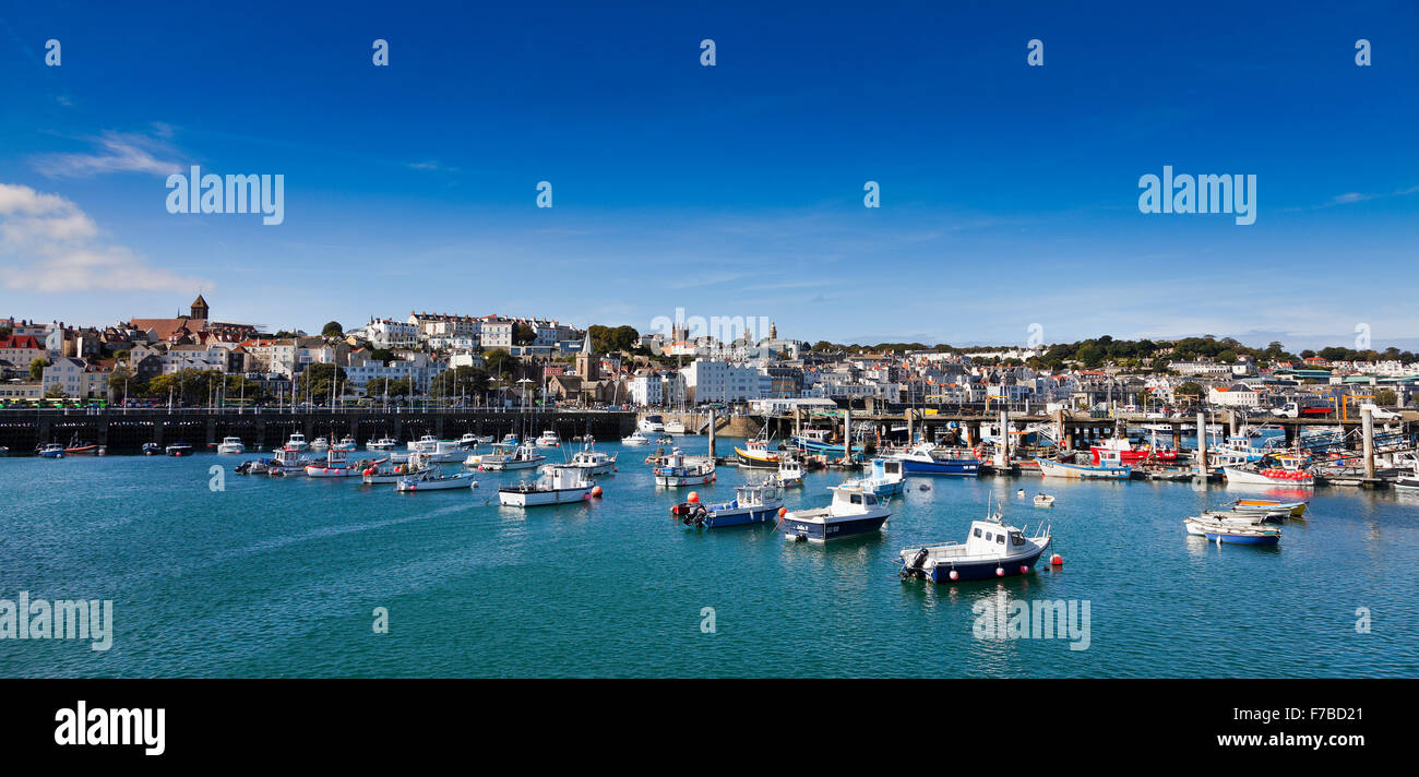 St Peters Port, Guernsey. Bright sunny day view looking inland over moored sailing boats Stock Photo