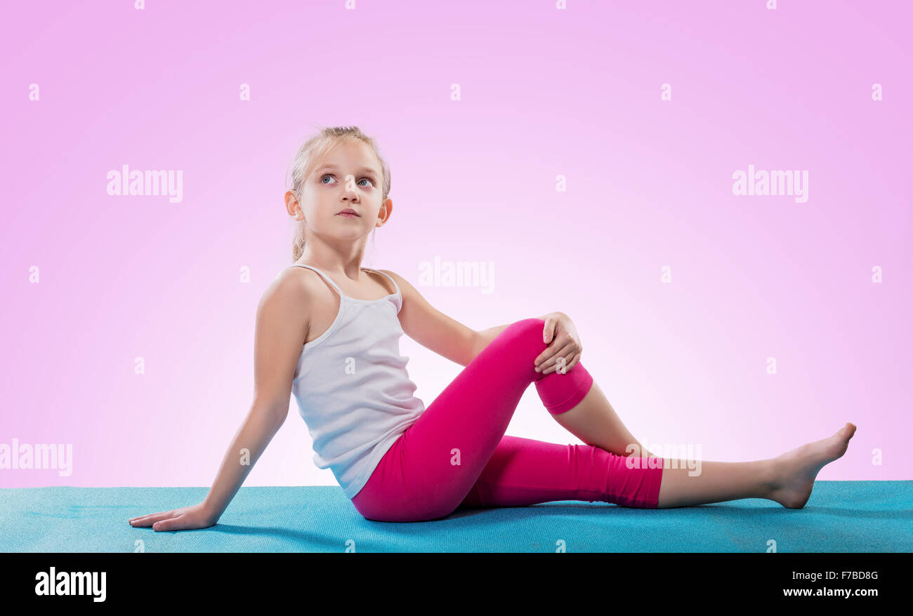 Little girl sitting in yoga pose Stock Photo - Alamy