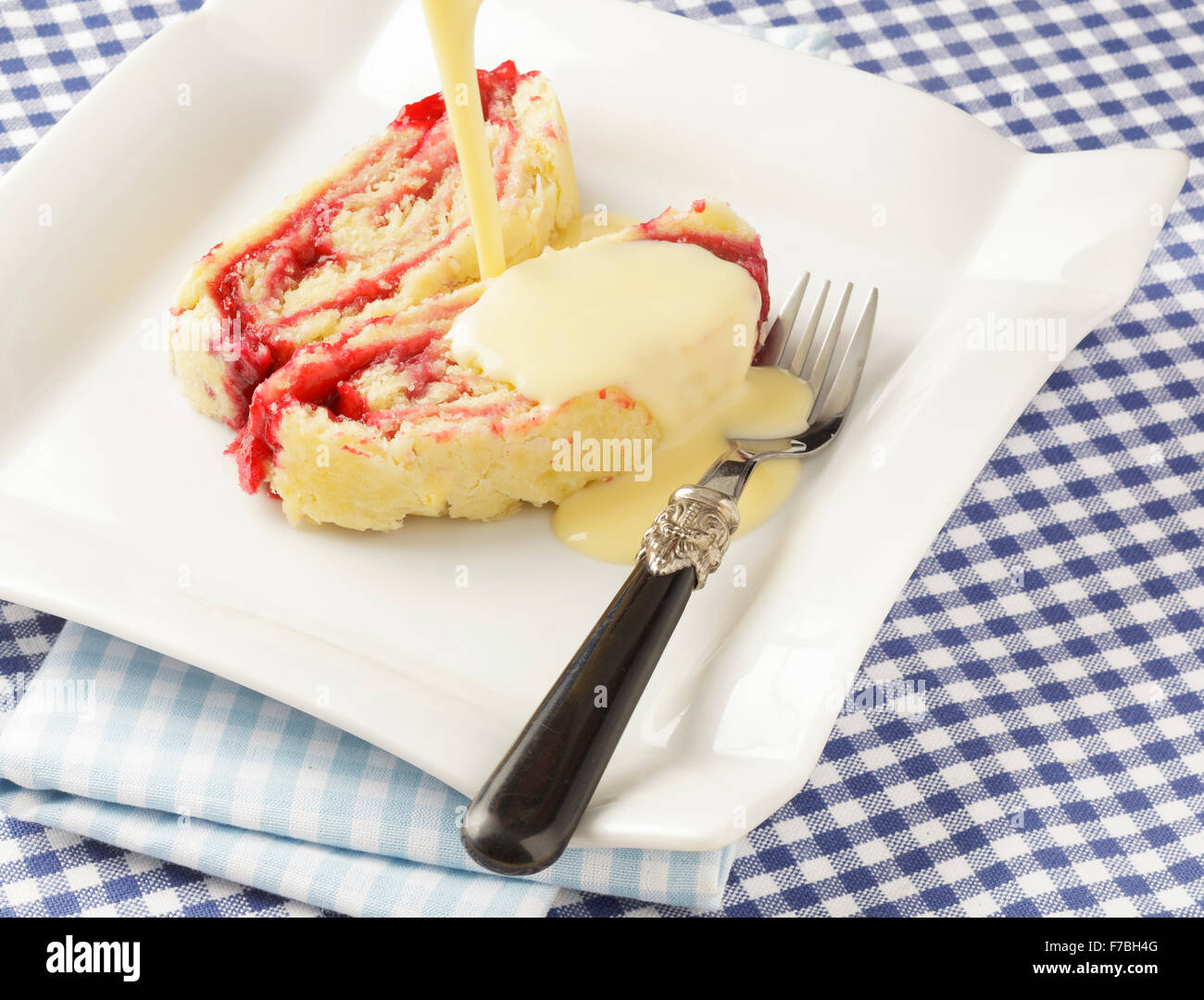 Jam Roly Poly and custard Stock Photo