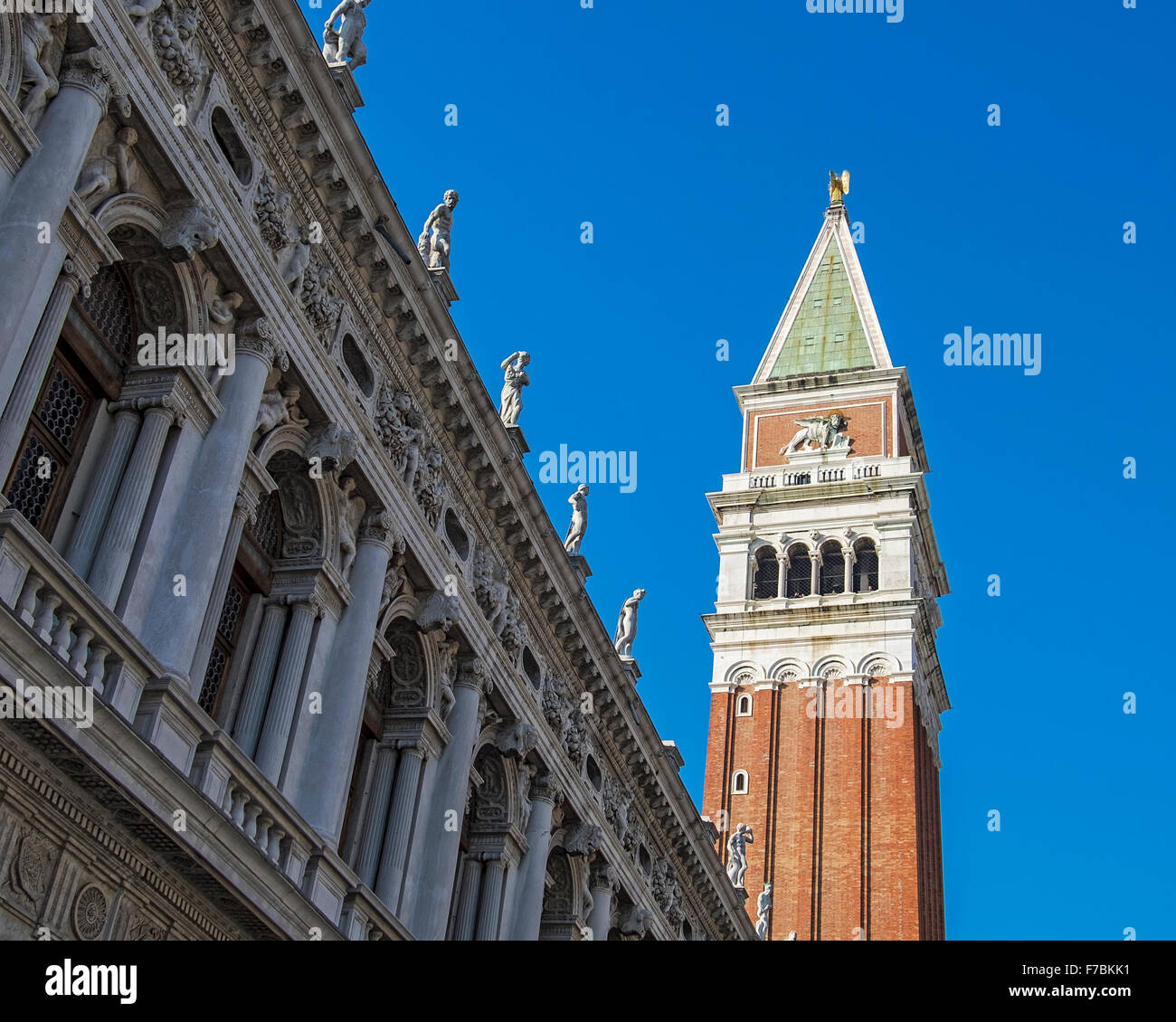 Venice, Italy. Biblioteca Nazionale Marciana, National library facade & Saint Mark's Campanile with blue sky Stock Photo