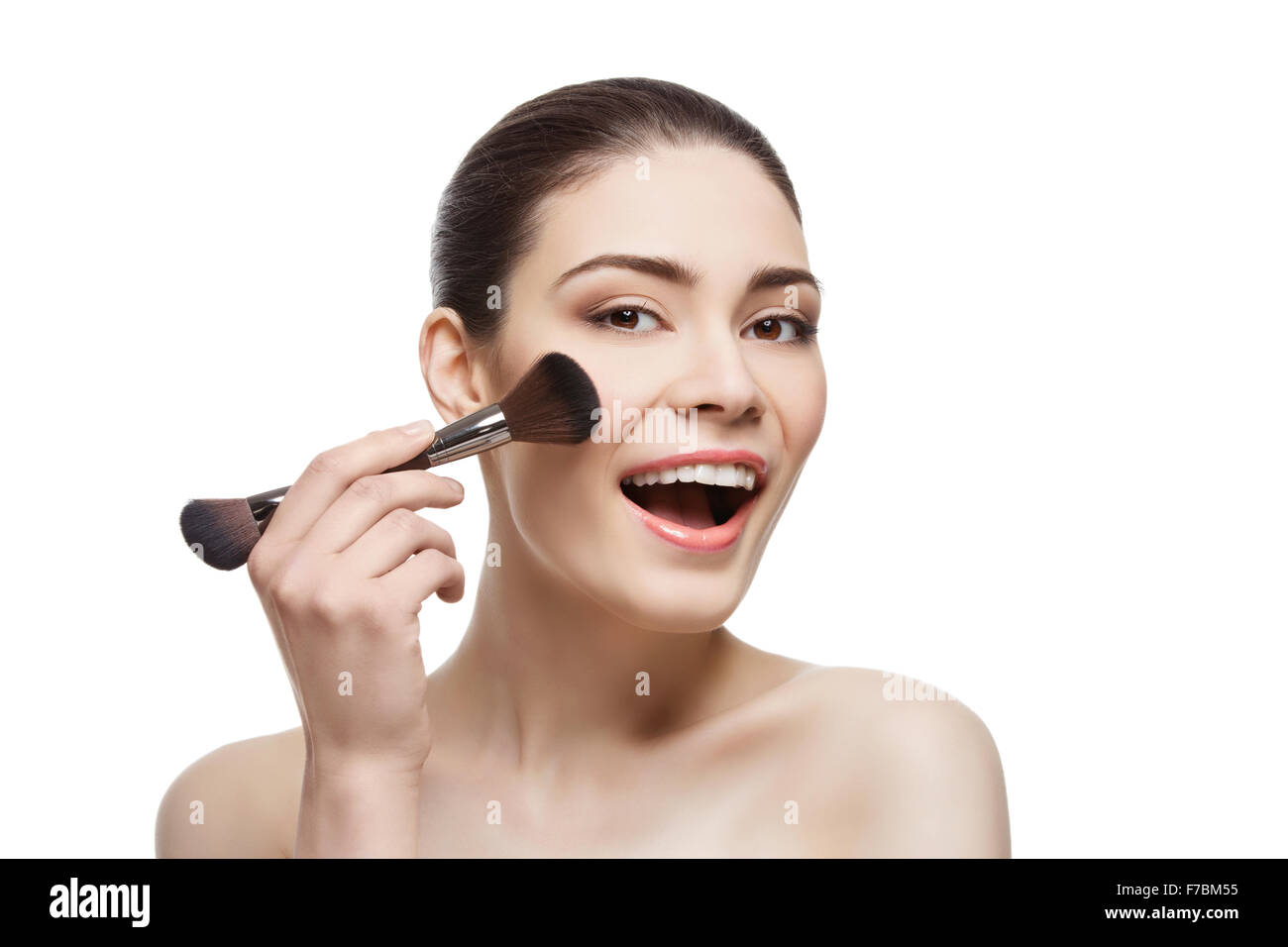 Beautiful happy girl applying blush with brush Stock Photo Alamy