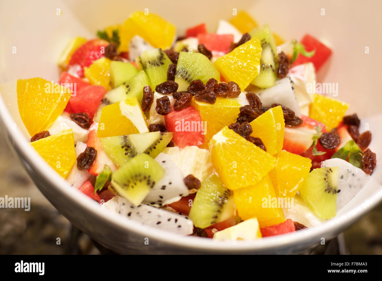 Delicious Fruit Salad with watermelon, oranges, kiwi and raisins Stock Photo