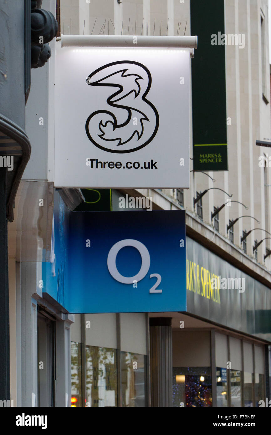 Three & O2 mobile network brand logos on high street Stock Photo