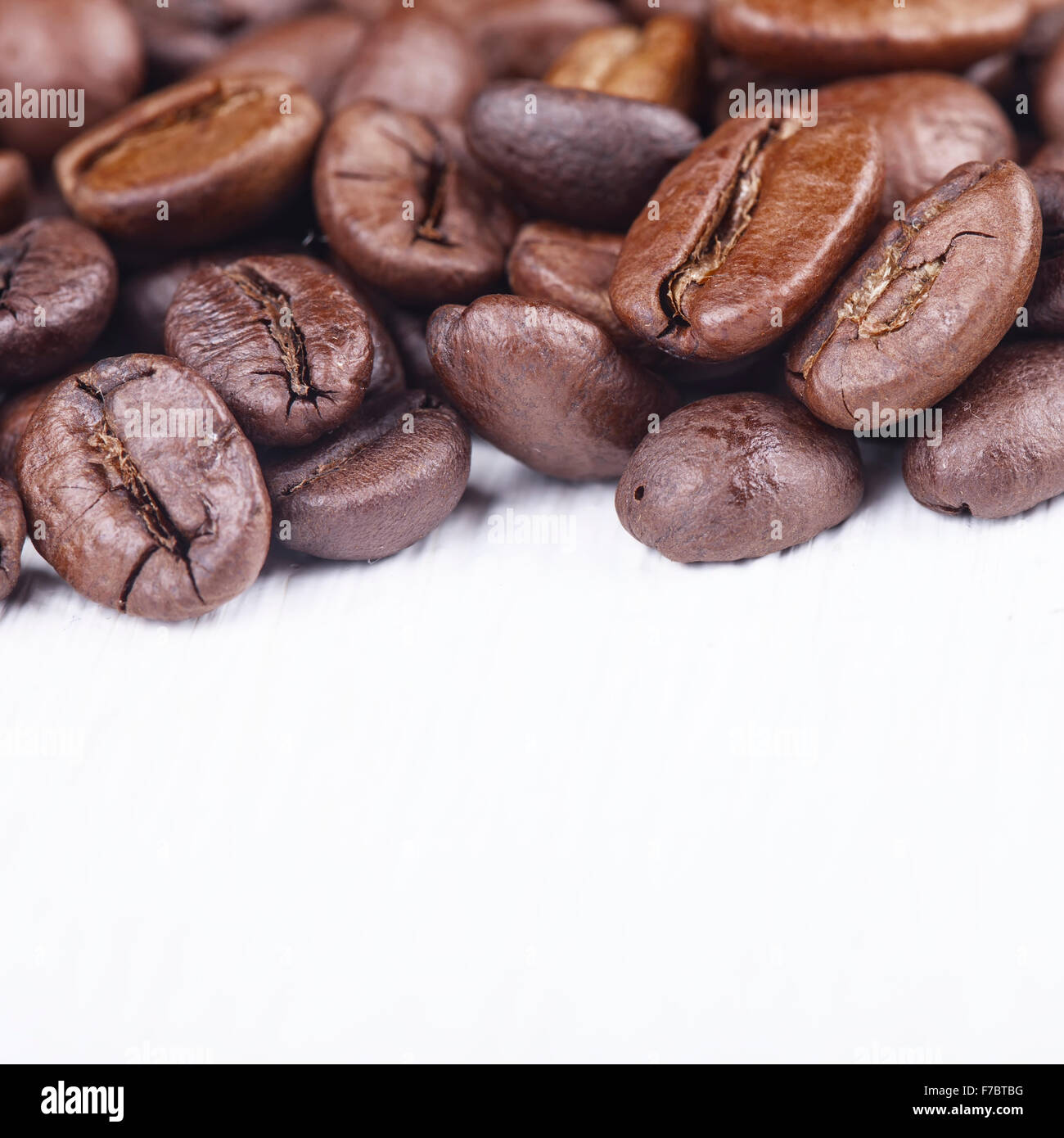 Macro image of coffee beans on white background Stock Photo - Alamy