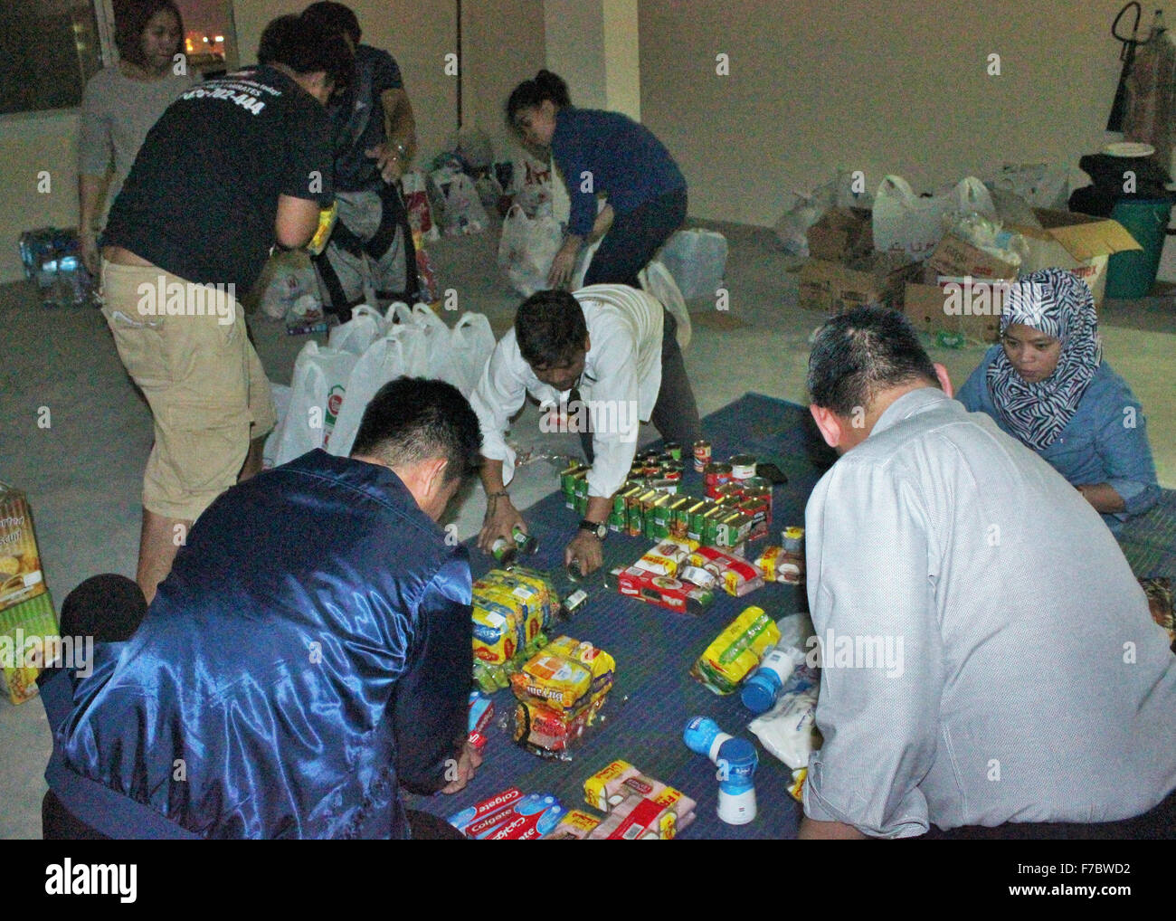 Dubai, United Arab Emirates. 25th Nov, 2015. Community Relations and Service Project Director Dubai Chapter Zeehan Pendaliday (extremely right) along with other SMPII officers and Filipino volunteers during their segregating donation procedure, Hundreds of Filipino 'The Deira Fire' victims arrived at their newly building flat relocation in Hor Al Anz. © Robert Oswald Alfiler/Pacific Press/Alamy Live News Stock Photo