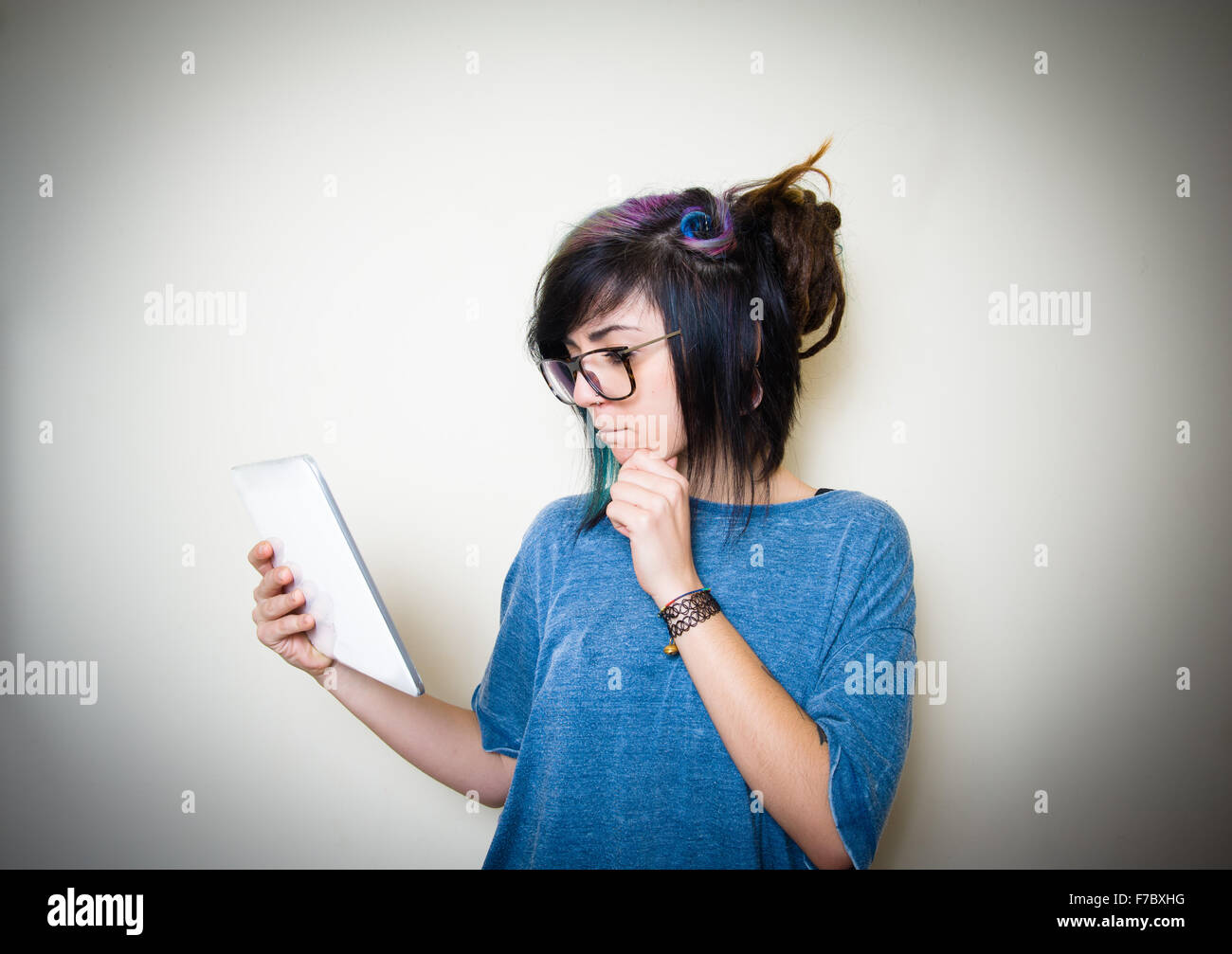 Pretty young teen woman using white tablet on white background Stock Photo