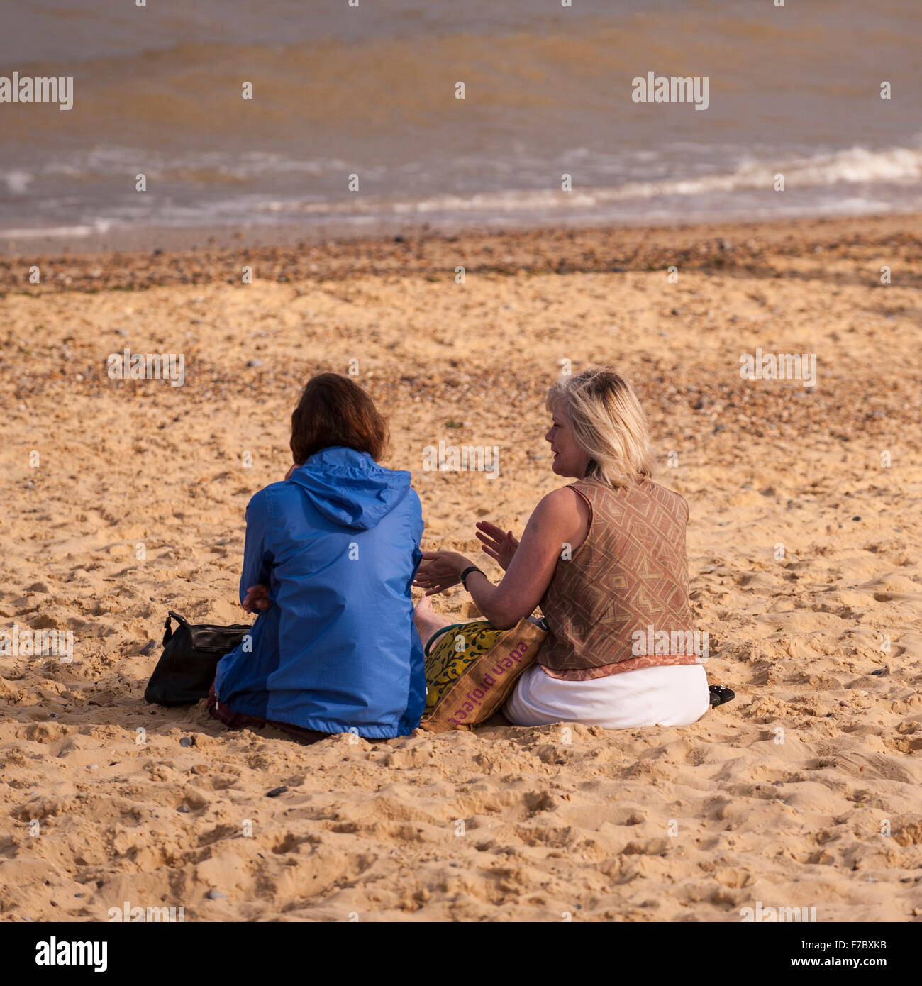 2 women enjoying the beach in Southwold , Suffolk , England , Britain , Uk Stock Photo