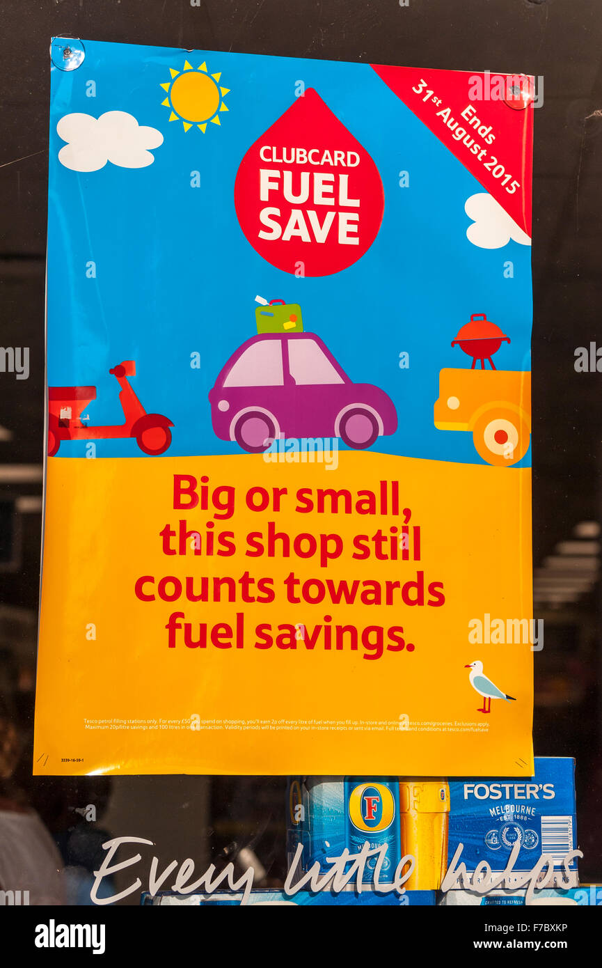 A poster advertising Tesco clubcard points in a Tesco shop window in the Uk Stock Photo