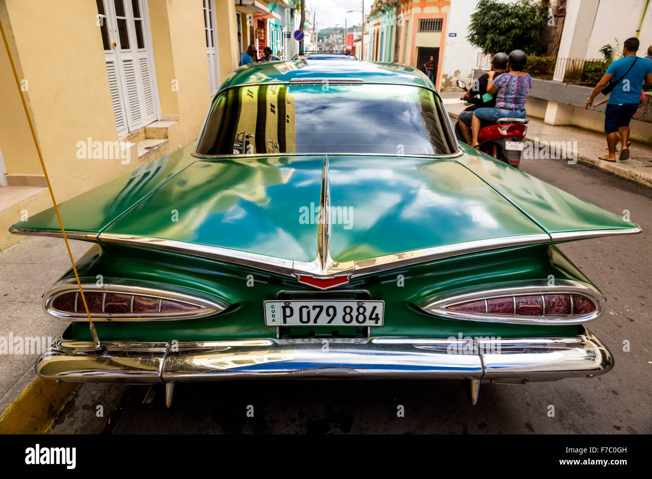 Vintage, historical street cruiser, green Impala, Streetlife in the center of Santa Clara at Parque de Santa Clara, Cuba, Stock Photo