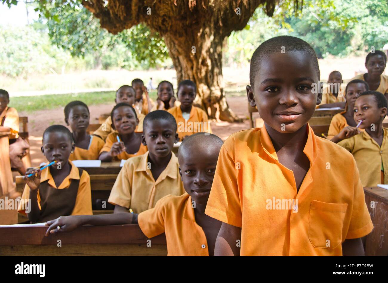 Young Ghanian children attend and outdoor classroom under a tree November 29, 2011 in the Northern Region of Ghana. Stock Photo