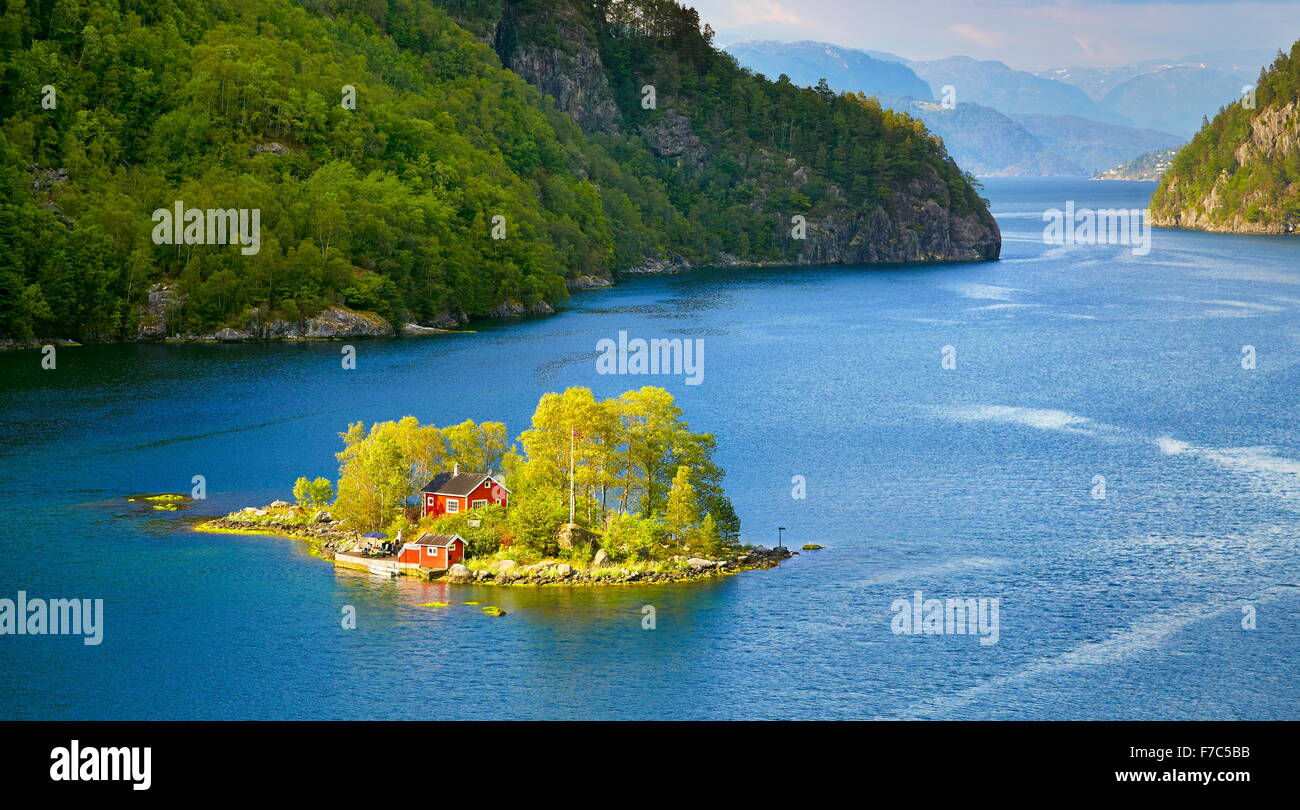 Small Island with a red cottage in Lovrafjord, Norway Stock Photo