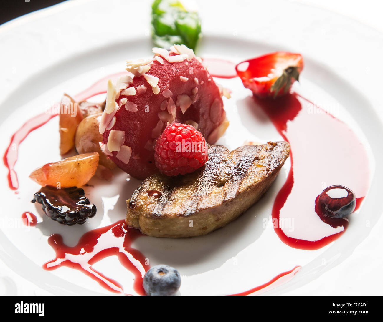 Gourmet appetizer: foie gras with berries. Stock Photo
