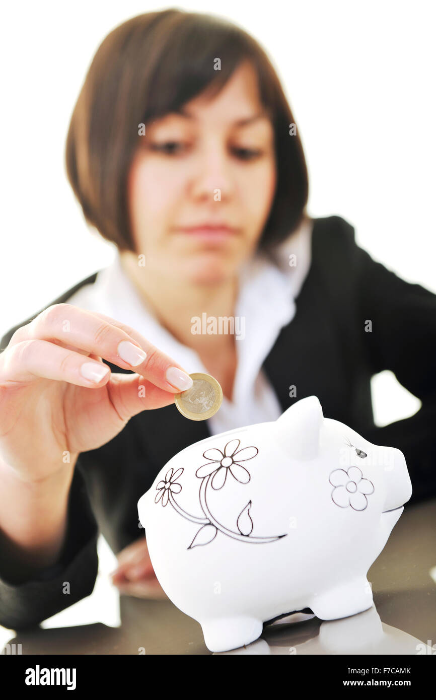 happy young business woman isolated on white puting euro money in piggy ...