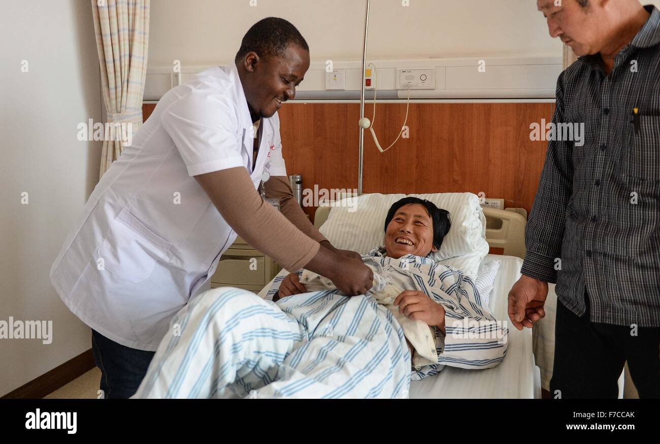 Changchun, China's Jilin Province. 27th Nov, 2015. Ramazani Nashiri (1st L), a medical student from Burundi, gives medical check for a patient at the First Hospital of Jilin University in Changchun, capital of northeast China's Jilin Province, Nov. 27, 2015. Nashiri, 40, has lived in China for nine years to study gynecology and obstetrics. He now is a PhD student at the Norman Bethune Health Science Center of Jilin University. A total of 528 foreign students studied medicine at the center, most of whom come from Asia and African nations. © Wang Haofei/Xinhua/Alamy Live News Stock Photo