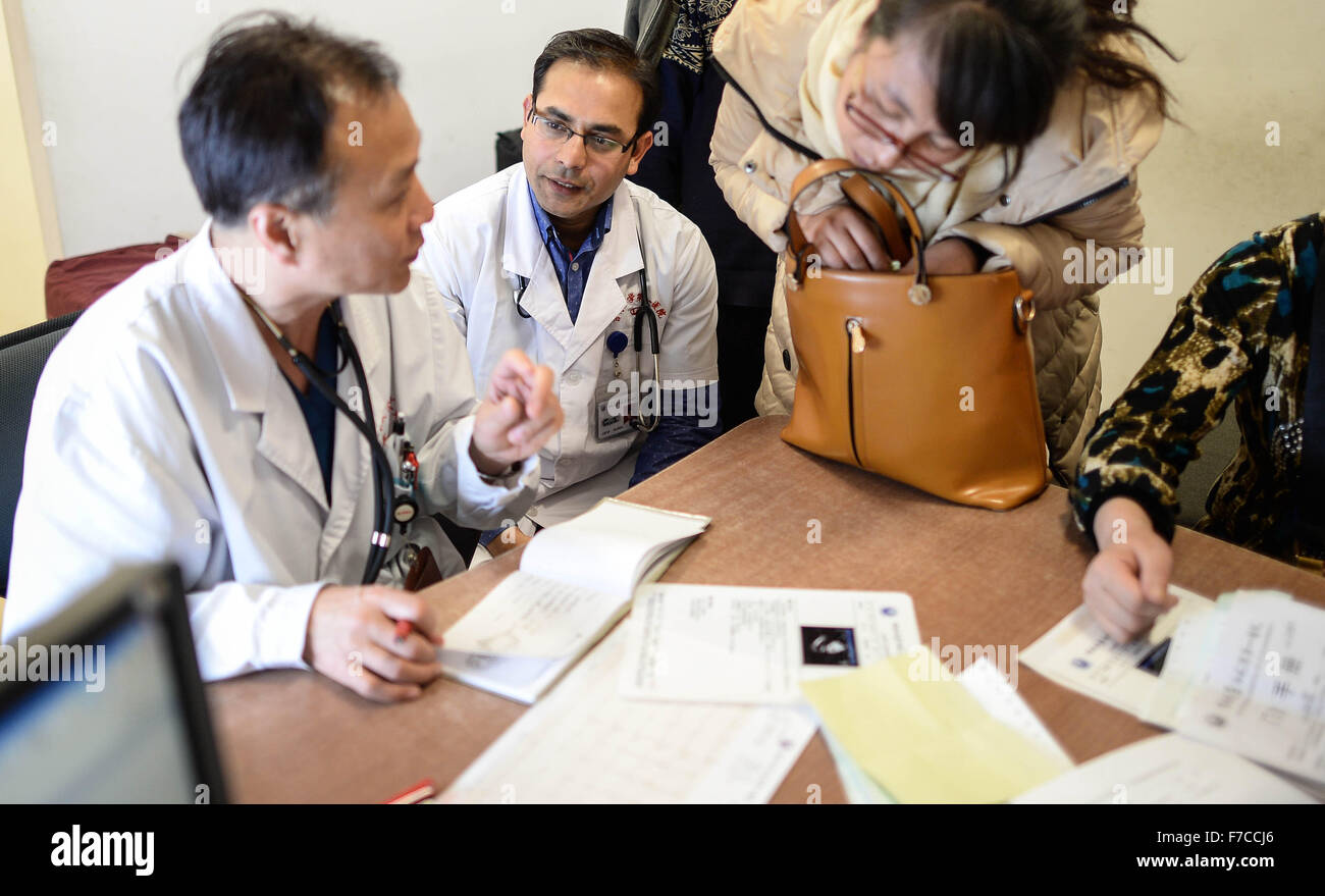 (151129) -- CHANGCHUN, Nov. 29, 2015 (Xinhua) -- Kumar Adhikari (2nd L), a medical student from Nepal, follows his PhD Supervisor to give medical check for patients at the First Hospital of Jilin University in Changchun, capital of northeast China's Jilin Province, Nov. 26, 2015. Adhikari, 30, has lived in China for 10 years to study cardiovascular medicine. He now is a PhD student at the Norman Bethune Health Science Center of Jilin University. A total of 528 foreign students studied medicine at the center, most of whom come from Asia and African nations. (Xinhua/Wang Haofei) (ry) Stock Photo