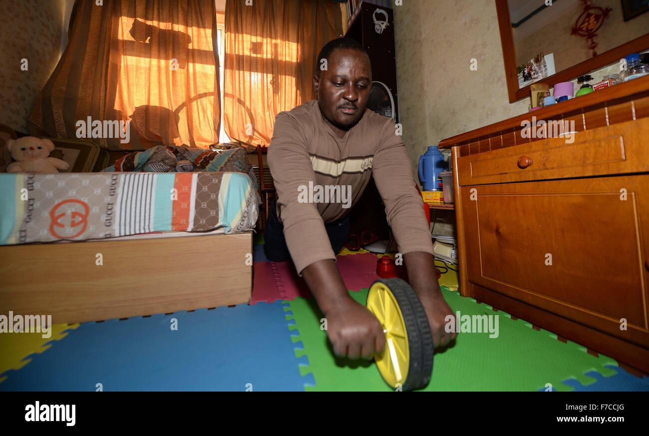 Changchun, China's Jilin Province. 27th Nov, 2015. Ramazani Nashiri, a medical student from Burundi, exercises at his dorm room in Changchun, capital of northeast China's Jilin Province, Nov. 27, 2015. Nashiri, 40, has lived in China for nine years to study gynecology and obstetrics. He now is a PhD student at the Norman Bethune Health Science Center of Jilin University. A total of 528 foreign students studied medicine at the center, most of whom come from Asia and African nations. © Wang Haofei/Xinhua/Alamy Live News Stock Photo